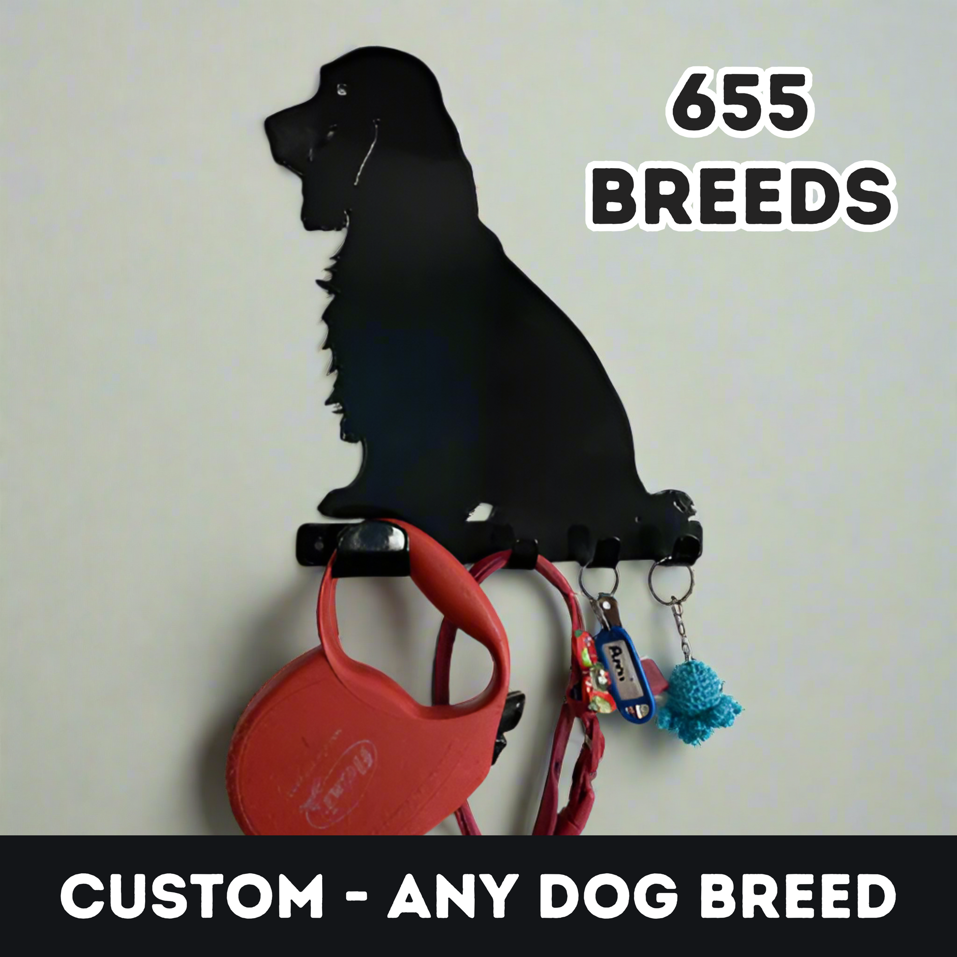 A black cocker spaniel dog key rack that is hanging on a wall, with a red dog lead, red dog collar, a set of keys, and a keyring hanging from the four hooks. Text reading 'Custom - Any Dog Breed - 655 Breeds' has been added to the image in post.