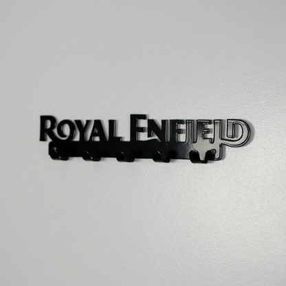 A right side view of a black metal key rack in the shape of the Royal Enfield logo, it has 5 hooks.